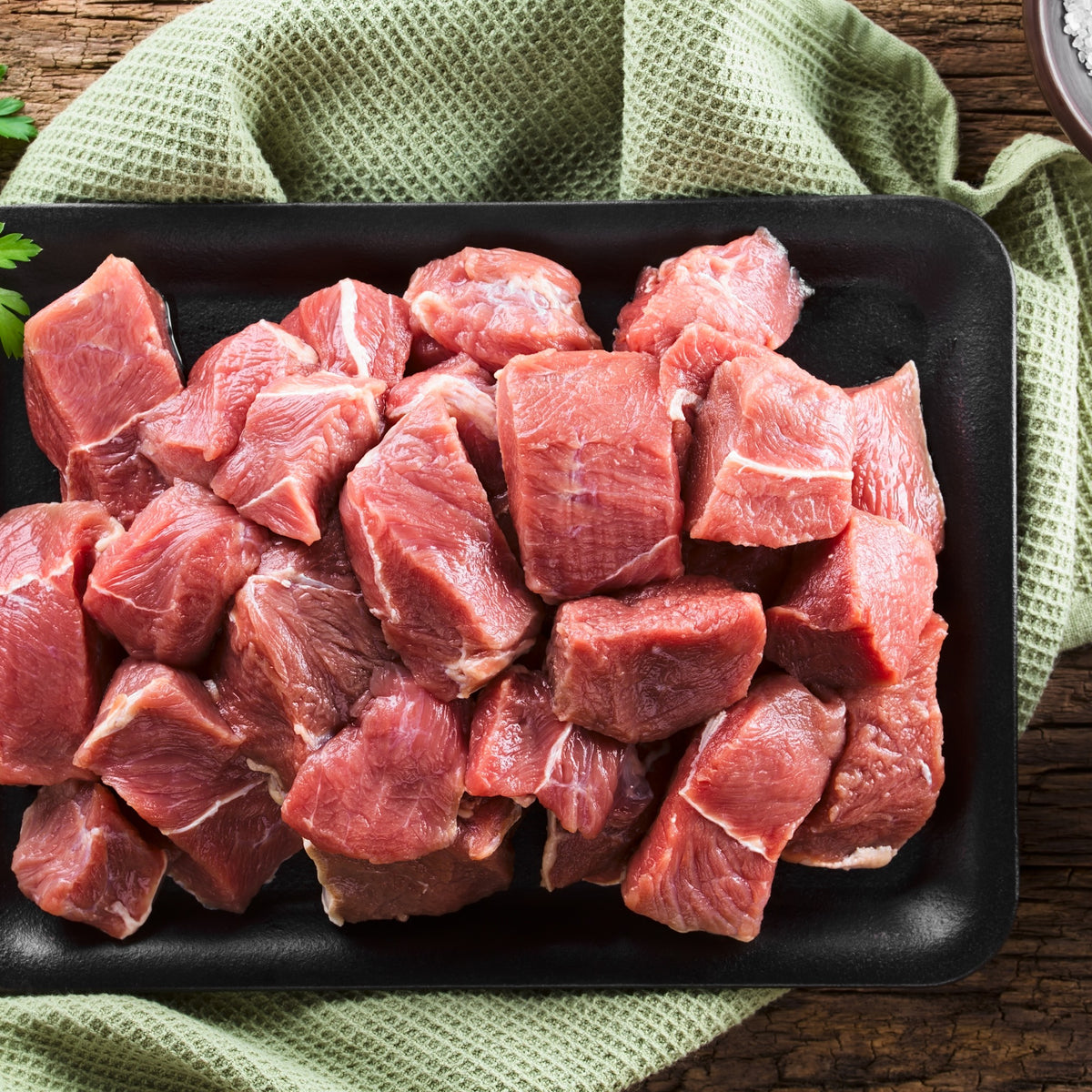 Raw beef kabob cubes in a tray with parsley — Stittsworth Meats, Bemidji MN