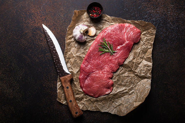Raw Stittsworth signature steak on parchment — Bemidji