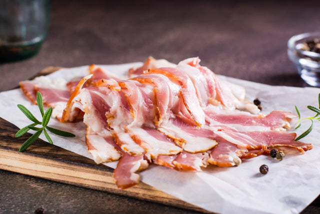 Raw house-smoked Stittsworth bacon on a board — Bemidji