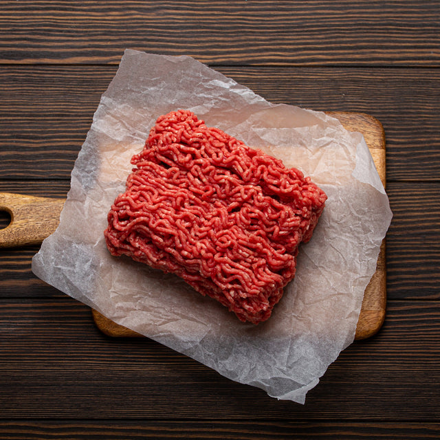 Bulk ground breakfast sausage on butcher paper and a wooden board — Stittsworth Meats, Bemidji MN