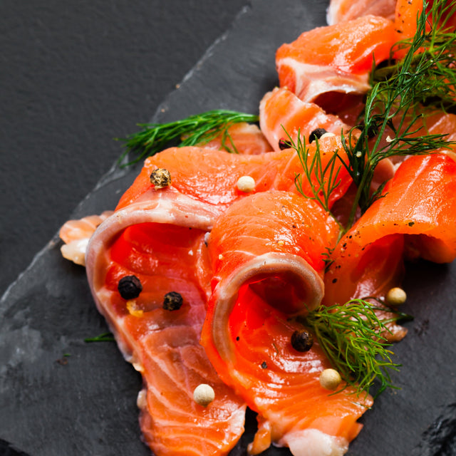 Sliced smoked salmon on slate with dill and peppercorns — Stittsworth Meats, Bemidji MN